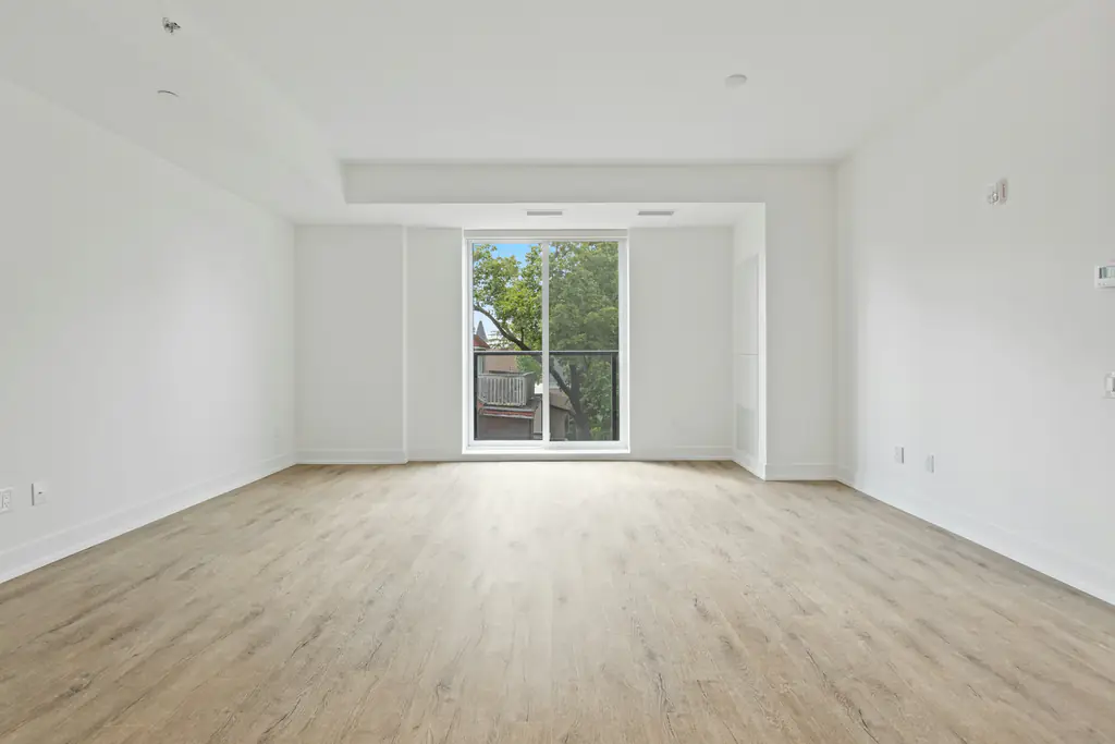 An empty room with fresh white walls and new timber flooring